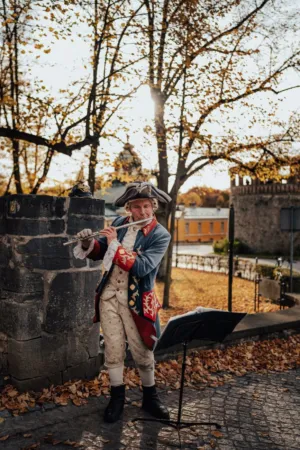 Man Playing Flute In Historical Costume