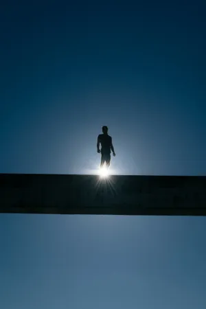 Silhouette Of A Man On A Bridge