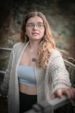 Young Woman With Glasses And Tattoo