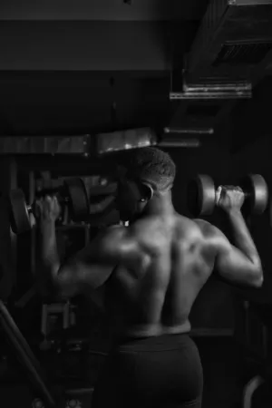 Muscular Man Lifting Dumbbells