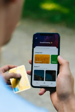 Person Holding Phone And Credit Card