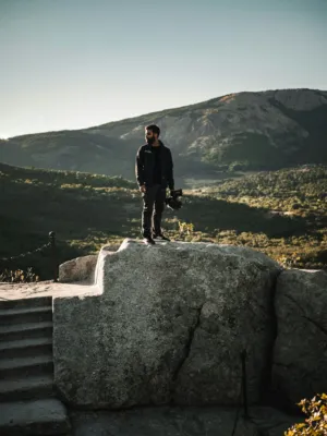 Man With Camera On Rock