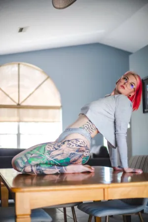Tattooed Woman In Home Setting