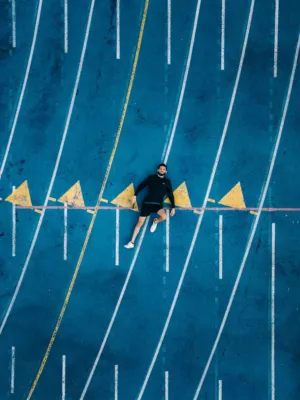 Man Lying On Blue Track