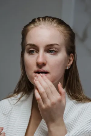 Young Woman Applying Lip Scrub