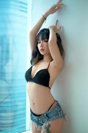 Fashion Model In Black Bra And Denim Shorts