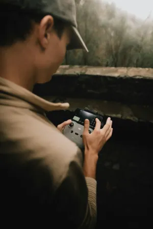Man Operating Drone Controller