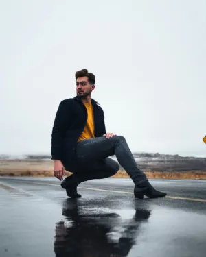 Crouching Man On Wet Road