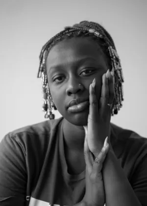 Portrait Of A Woman With Braids And Beads