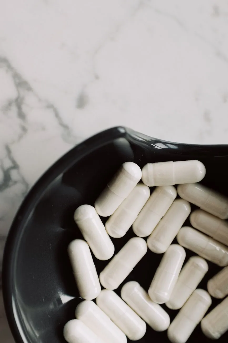 White Capsules On A Black Plate