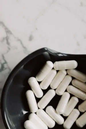White Capsules On A Black Plate