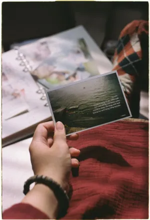 Hand Holding A Postcard