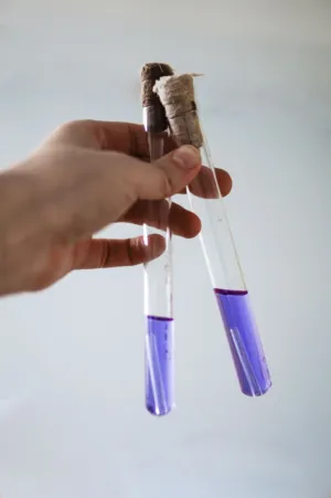 Hand Holding Test Tubes
