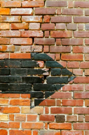 Brick Wall With Black And Orange Tiles
