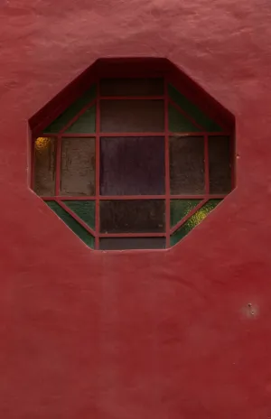 Octagonal Window On Red Wall
