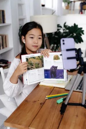 Child Studying With Book And Smartphone