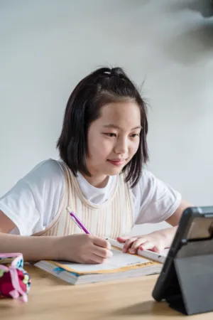 Teenage Girl Studying With Tablet