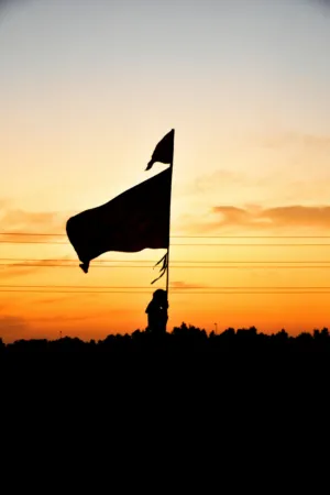 Silhouette Of A Flag At Sunset