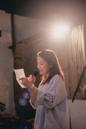 Young Woman Reading From A Sheet Of Paper
