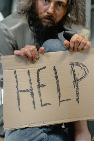 Homeless Man Holding 'Help' Sign