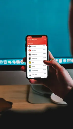Hand Holding A Smartphone Displaying A Channel List