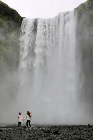 Two People At Skógafoss Waterfall