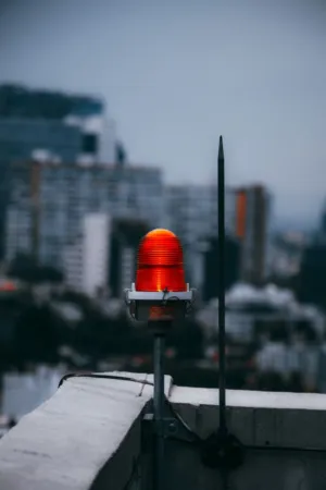 Red Warning Light On Urban Rooftop