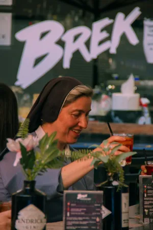 Nun Enjoying A Drink