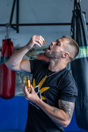 Man In Gym With Essential Oil