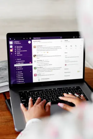 Person Using A Laptop With Slack Interface