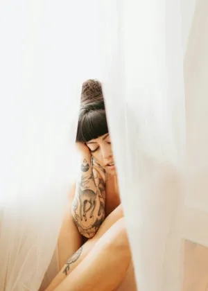 Tattooed Woman Behind Curtain