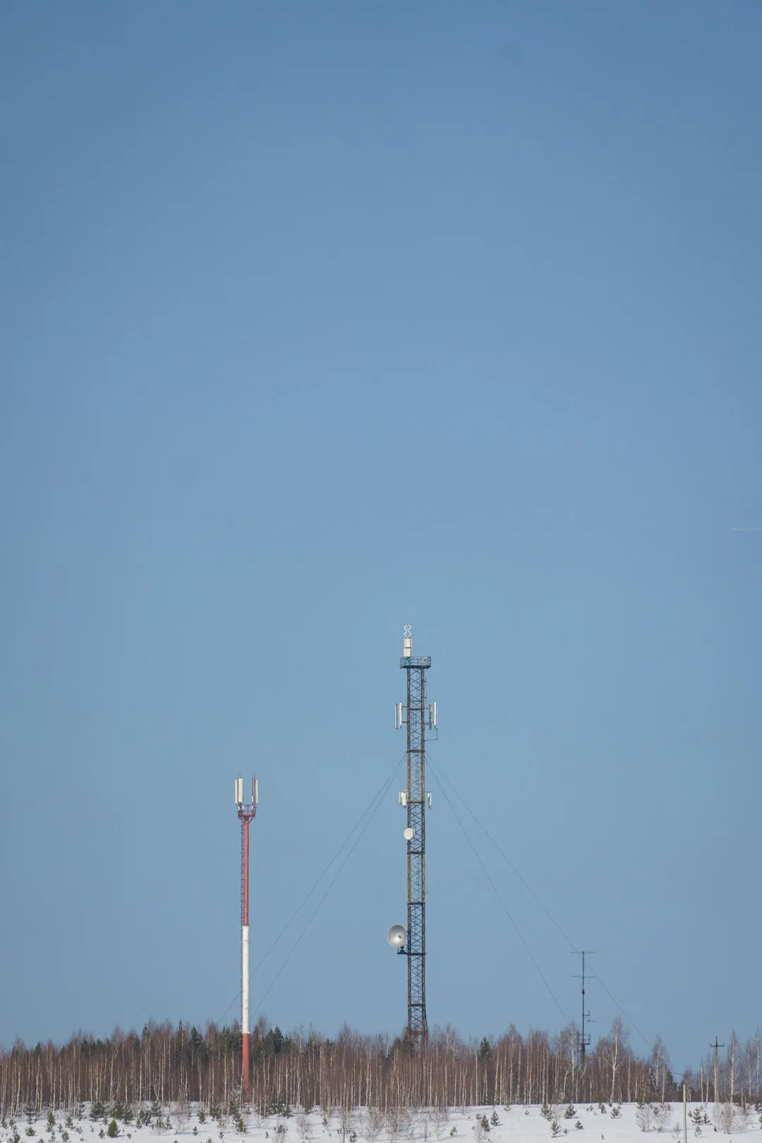 Communication Towers In Winter Landscape