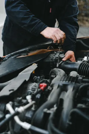 Mechanic Working On Car Engine
