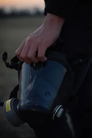 Person Holding Gas Mask