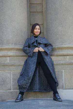 Fashionable Woman In Front Of Stone Wall