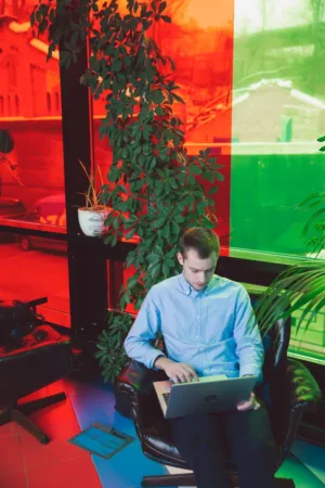 Man Working On Laptop In Colorful Office