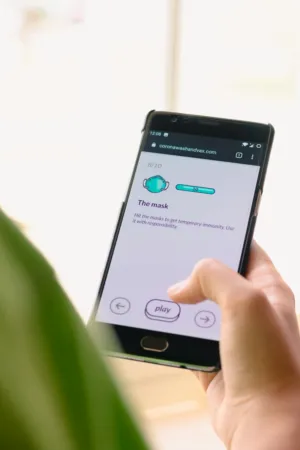 Hand Holding Smartphone With Mask Game