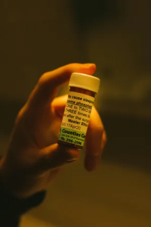 Hand Holding Medicine Bottle
