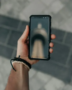 Hand Holding Smartphone With Blurred Image