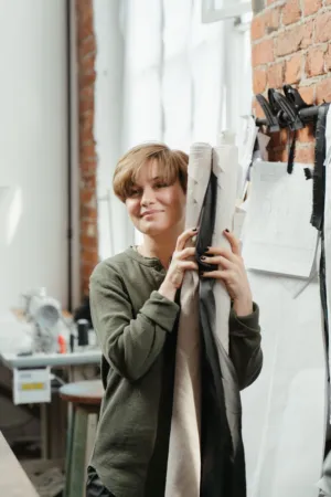 Fashion Designer Holding Fabric Rolls