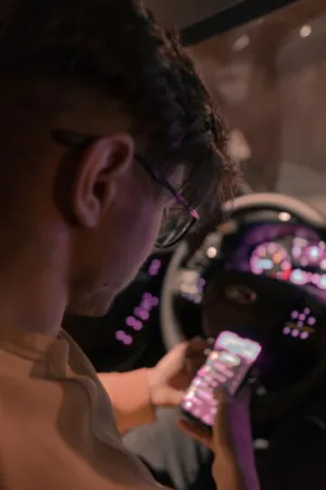 Man With Glasses Using Phone In Car