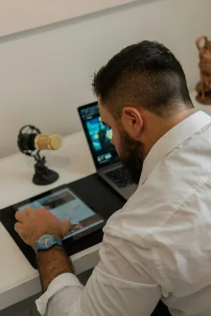 Man Working On Laptop And Tablet