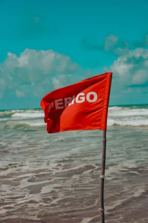 Red Perigo Flag On Beach