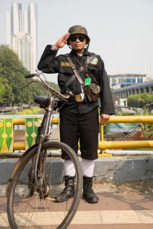Military Officer Saluting With Bicycle