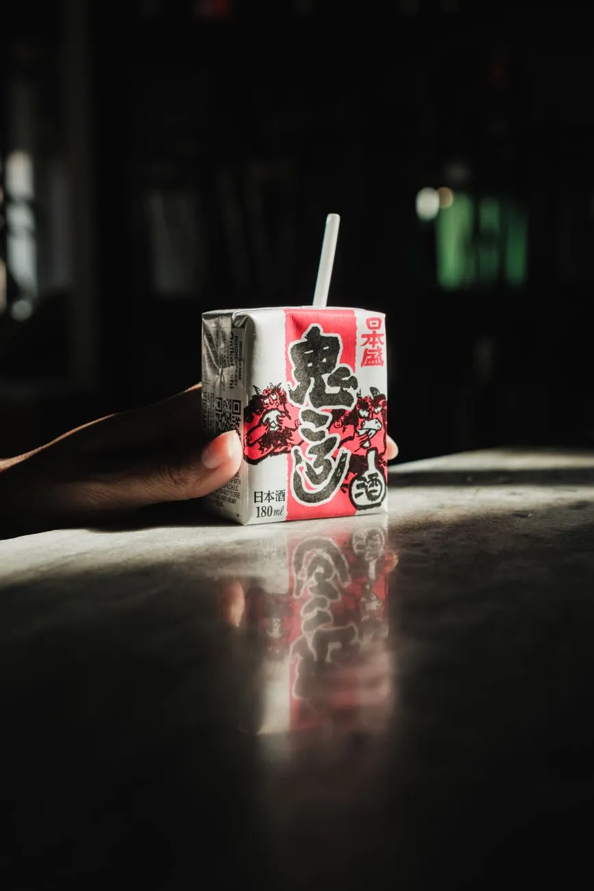 Hand Holding Japanese Sake Carton