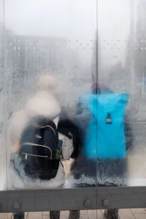 Reflection Of A Person With A Backpack