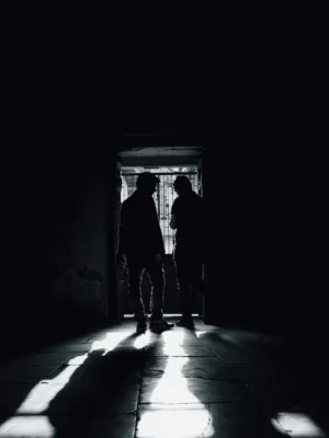 Silhouettes In Dark Hallway