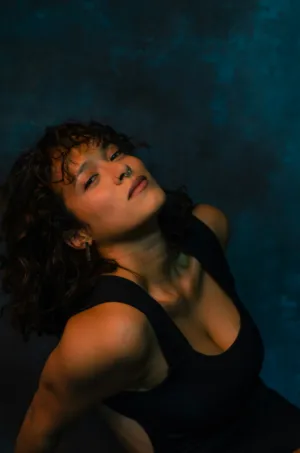 Curly-Haired Model In Black Dress