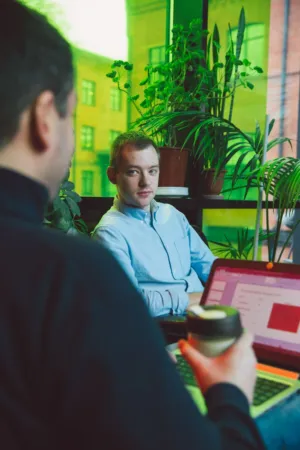 Two Men Working In A Green Office