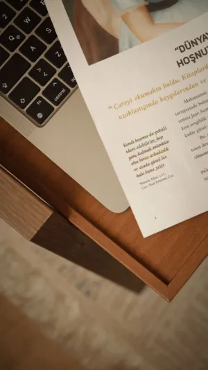 Laptop And Book On Wooden Surface